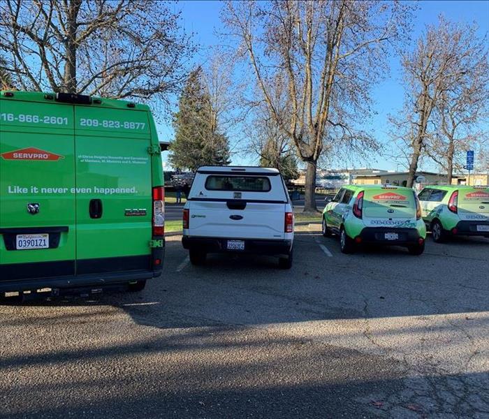 SERVPRO van and vehicles parked 